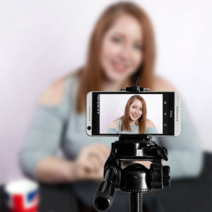 Tessa using a smartphone for video conferencing.