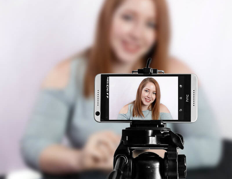 Tessa using a smartphone for video conferencing.