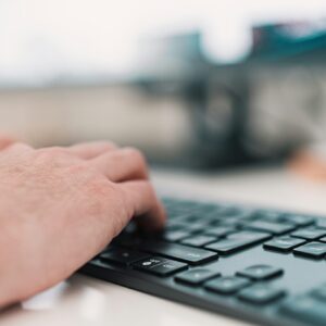 person using black computer keyboard